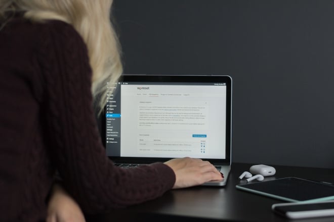 Blonde Woman Using Laptop For Work - Best WordPress Themes