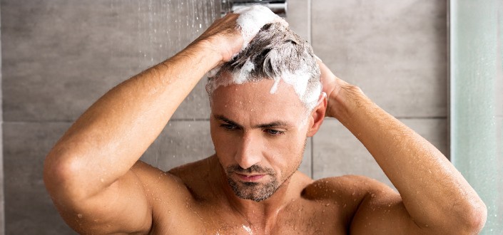 man washing hair with shampoo
